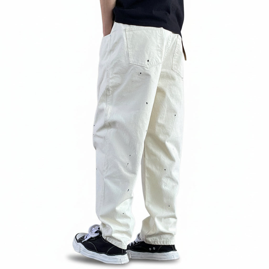 Distressed camouflage trousers bold paint-splatter accents pants