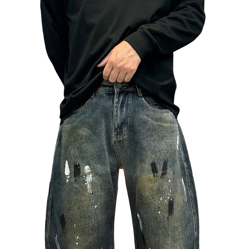 Distressed splashed ink jeans trousers
